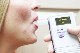 Woman using breathalyzer